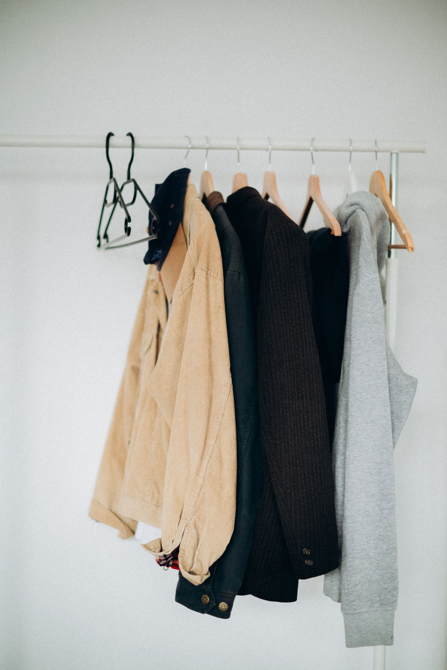 A selection of fashionable clothes hanging on wooden hangers, perfect for style inspiration.