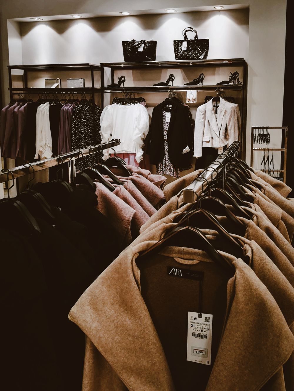 Stylish clothing racks in a modern store showcasing various garments.