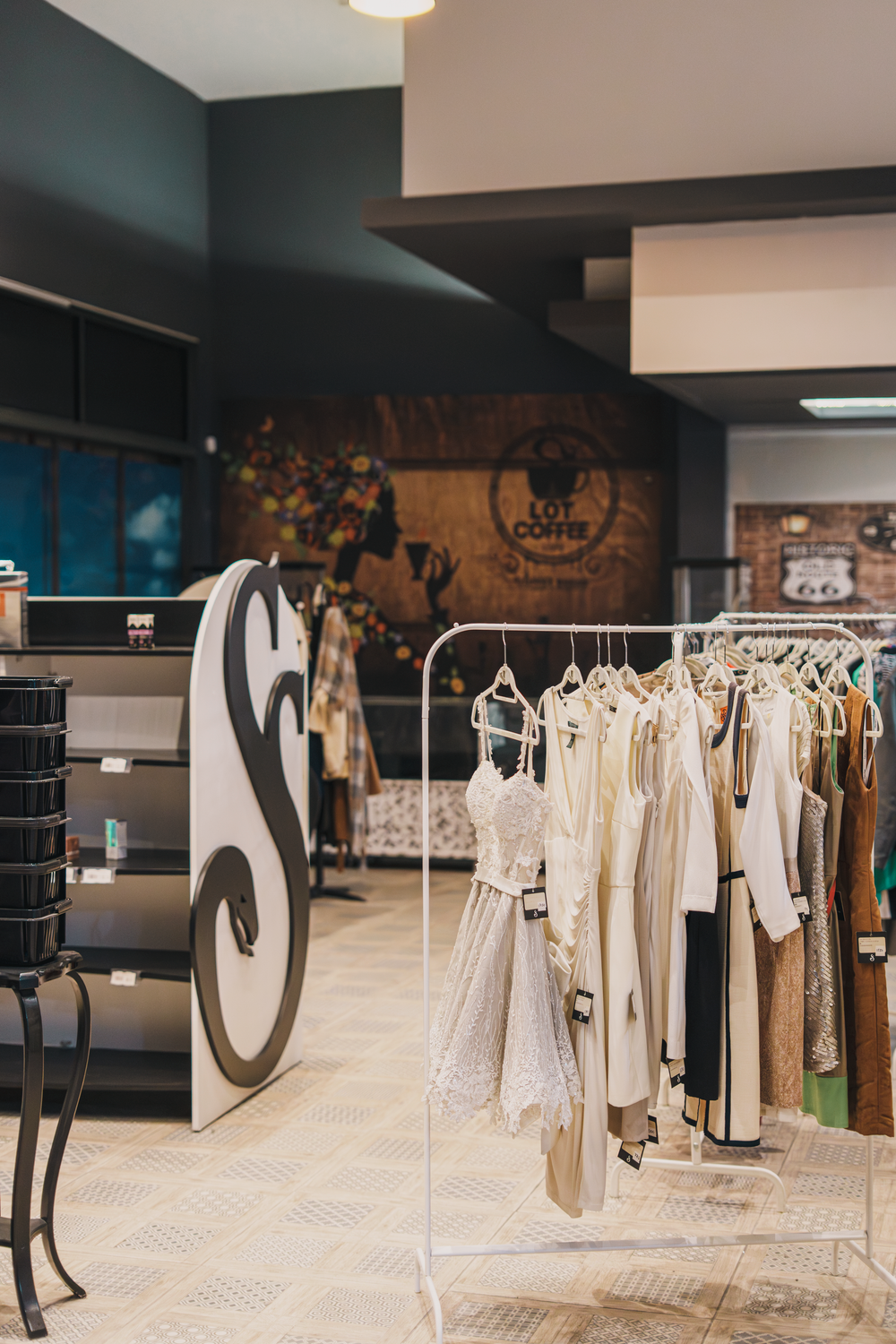 Stylish fashion boutique interior with elegant dress display and artistic decor for sophisticated shopping experience.