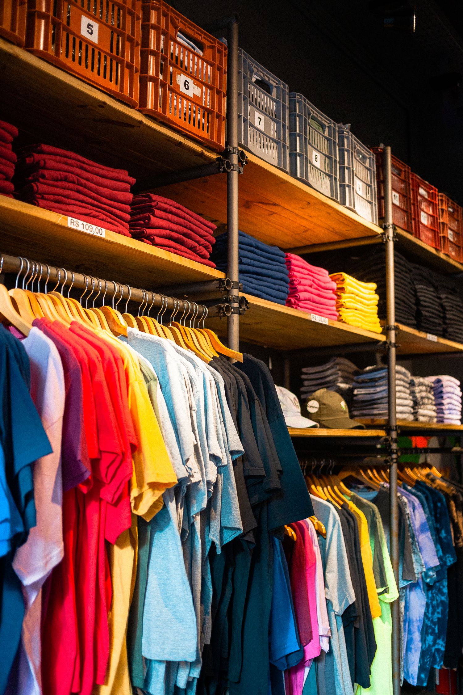 Vibrant t-shirts neatly displayed in an organized boutique setting.