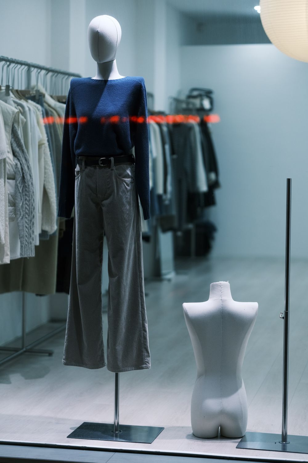Fashionable clothing display with a mannequin in a trendy store window.