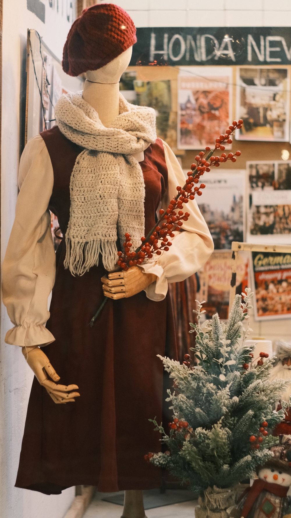 Charming vintage-style mannequin in winter attire with festive decor, perfect for holiday inspiration.
