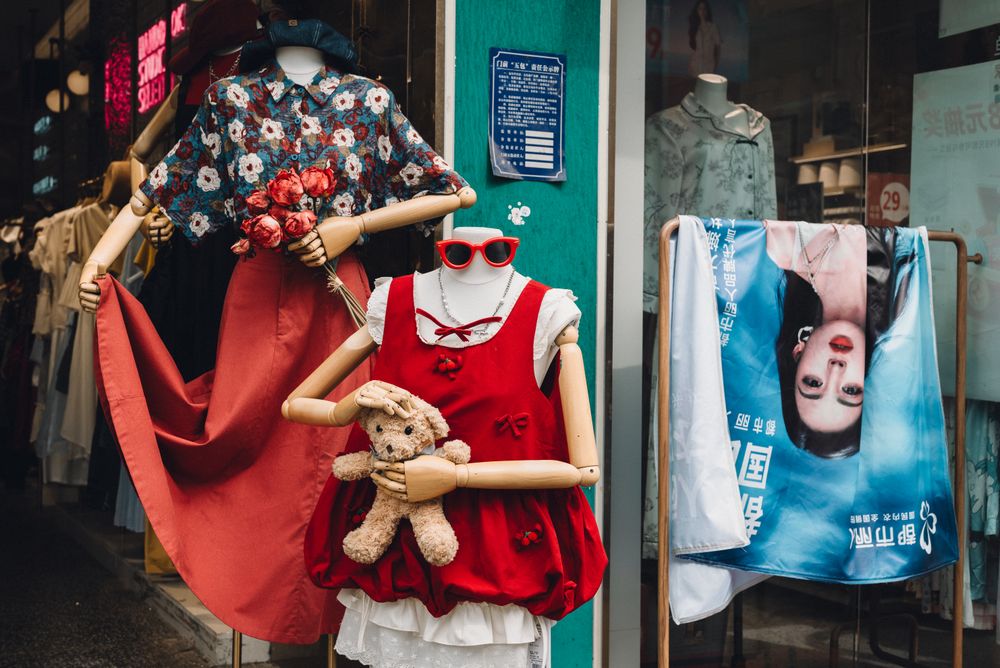 Vibrant street fashion display with mannequins wearing stylish outfits and accessories.