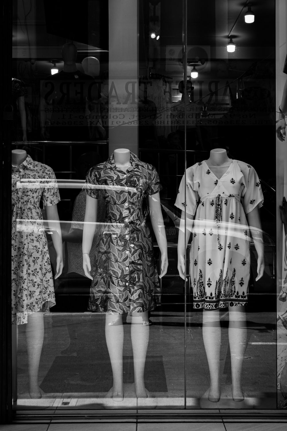 Black and white photo of mannequins showcasing dresses in a store in Colombo.
